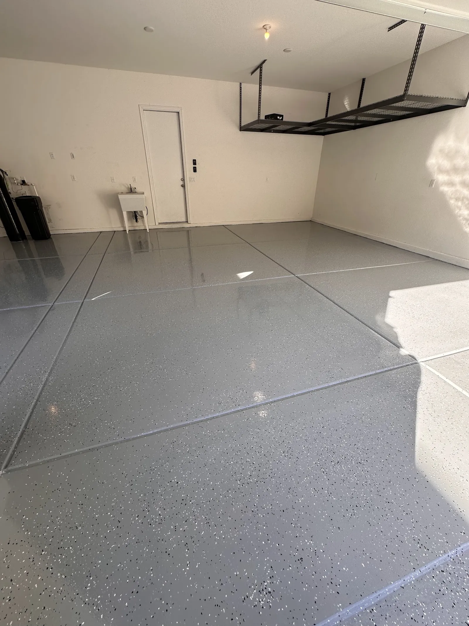 Finished epoxy floor coating in a residential garage